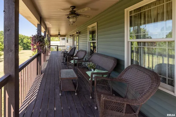a view of balcony with furniture and wooden floor