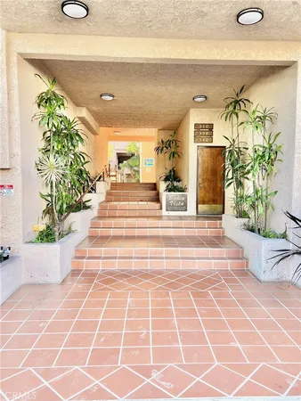a lobby with furniture and potted plants