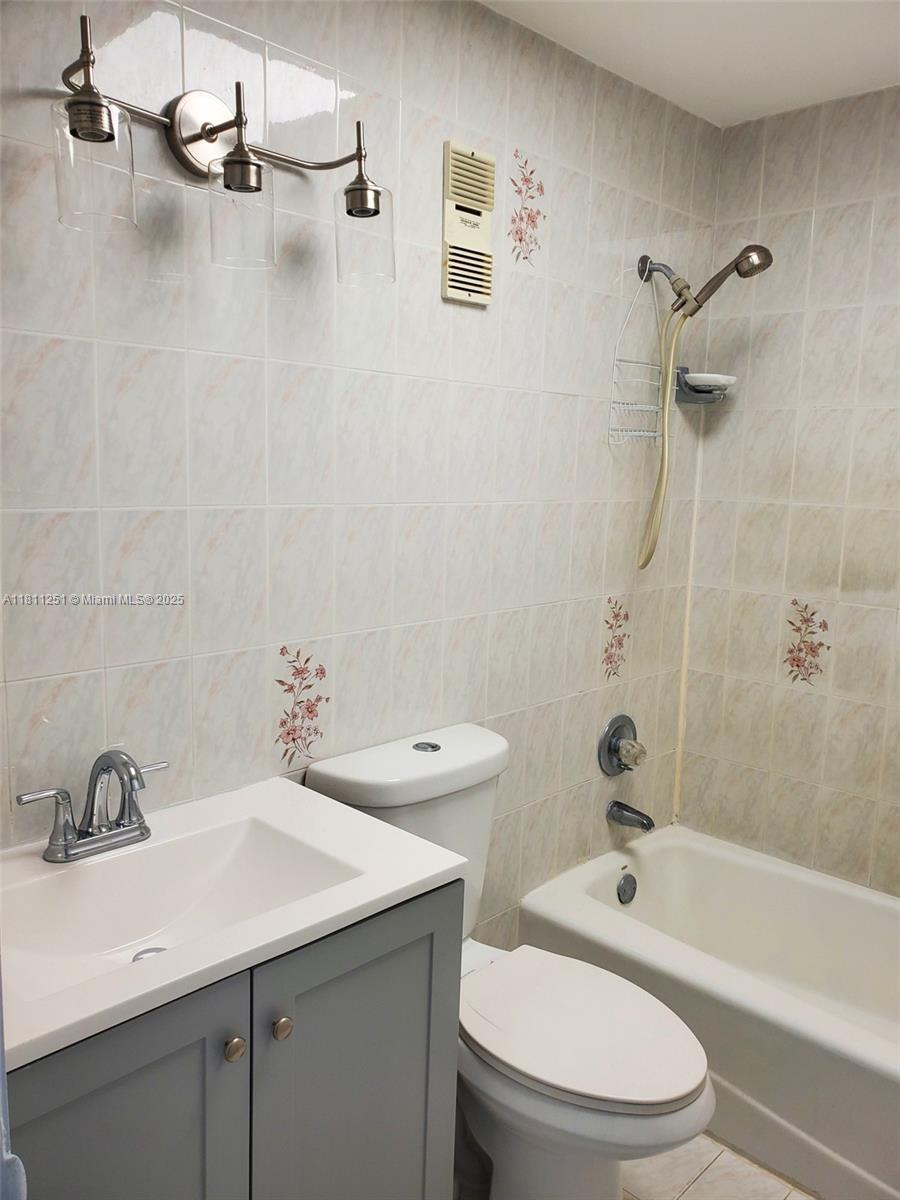 14250 Southwest 62nd Street, Unit 505 Miami, FL 33183 - Photo 13 of 38 a bathroom with a sink a toilet and shower