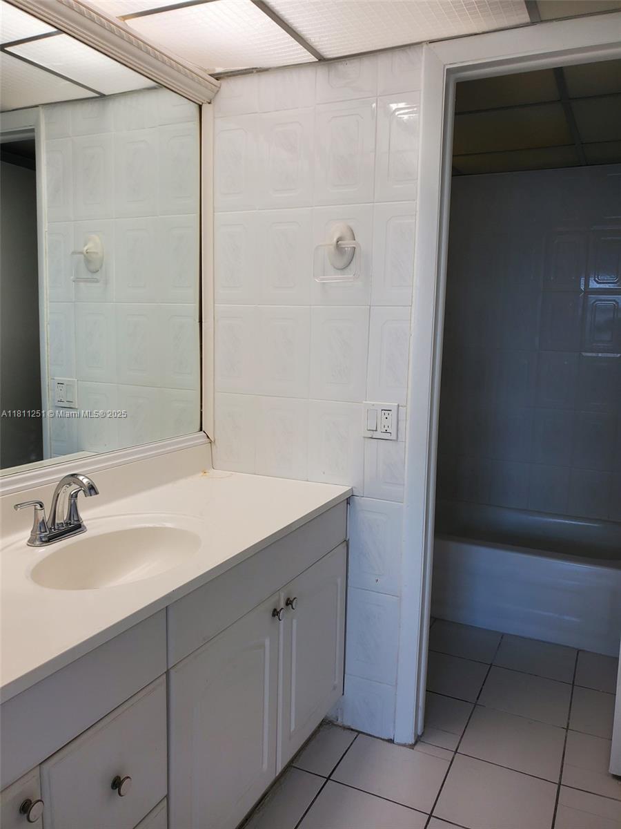 14250 Southwest 62nd Street, Unit 505 Miami, FL 33183 - Photo 25 of 38 a bathroom with a sink and a mirror