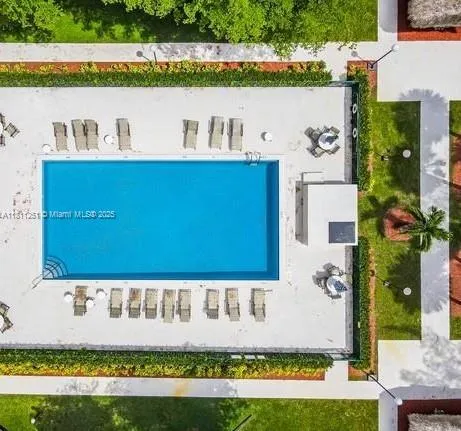 a view of a house with a swimming pool and a yard