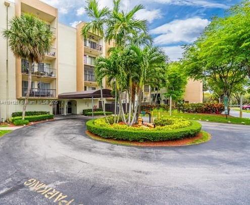14250 Southwest 62nd Street, Unit 505 Miami, FL 33183 - Photo 5 of 38 a front view of a house with a yard and garage