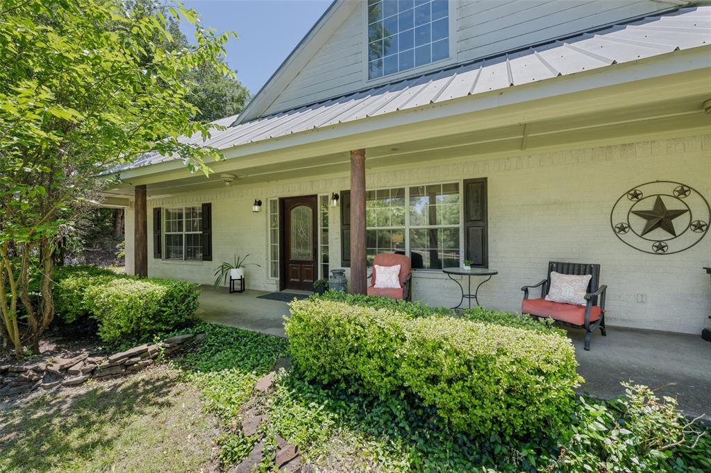 1000 Ballard Road Van Alstyne, TX 75495 - Photo 7 of 40 a view of a house with backyard sitting area and garden