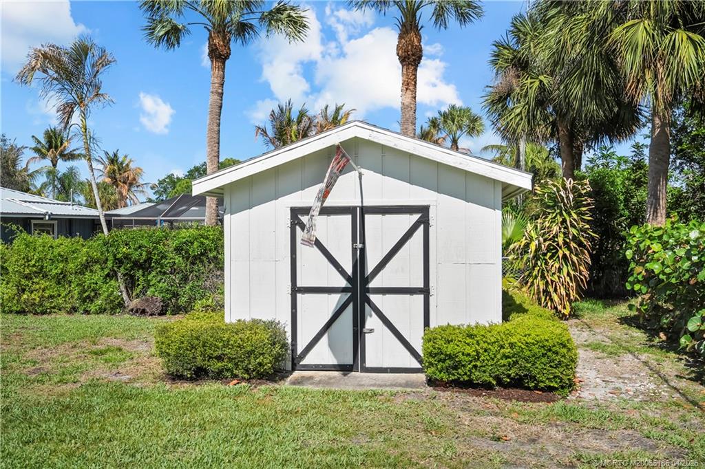 4620 Southeast Quail Trail Stuart, FL 34997 - Photo 56 of 71 a front view of a house with garden