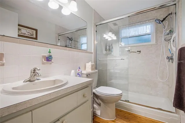 a bathroom with a sink toilet and shower