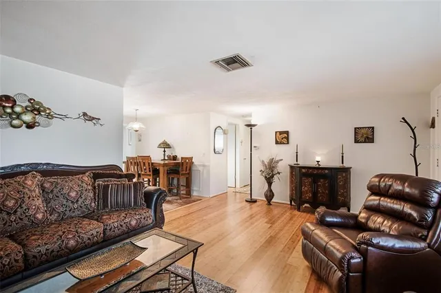 a living room with furniture fireplace and a window