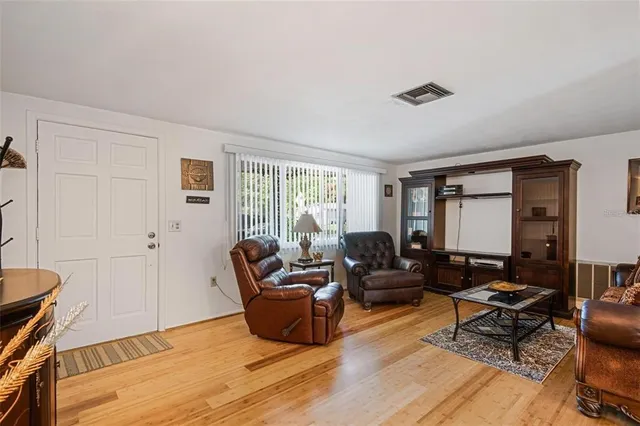 a living room with furniture rug and wooden floor