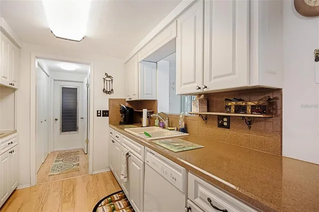 a kitchen with a sink a stove and a refrigerator