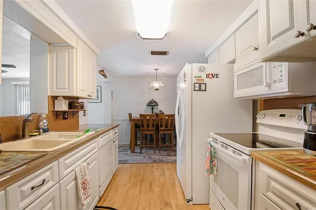 a kitchen with a sink a stove and cabinets