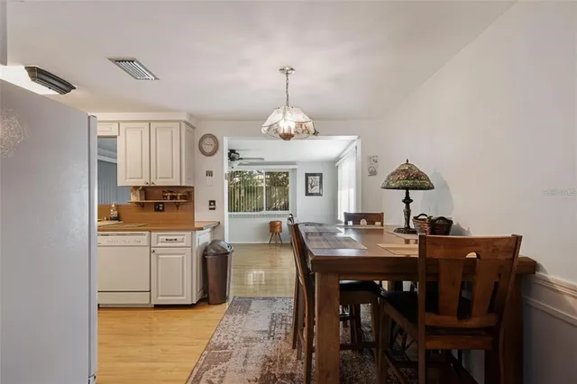 a dining room with granite countertop a table and chairs