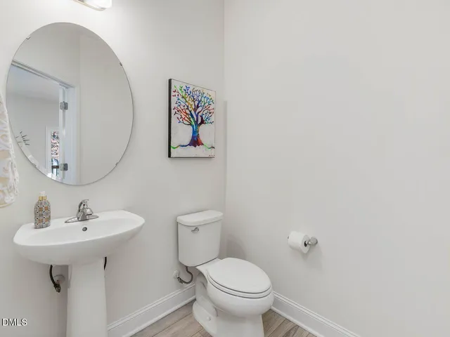 a living room with furniture a flat screen tv and a large window