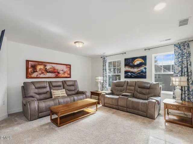 a spacious bedroom with two beds and a large window