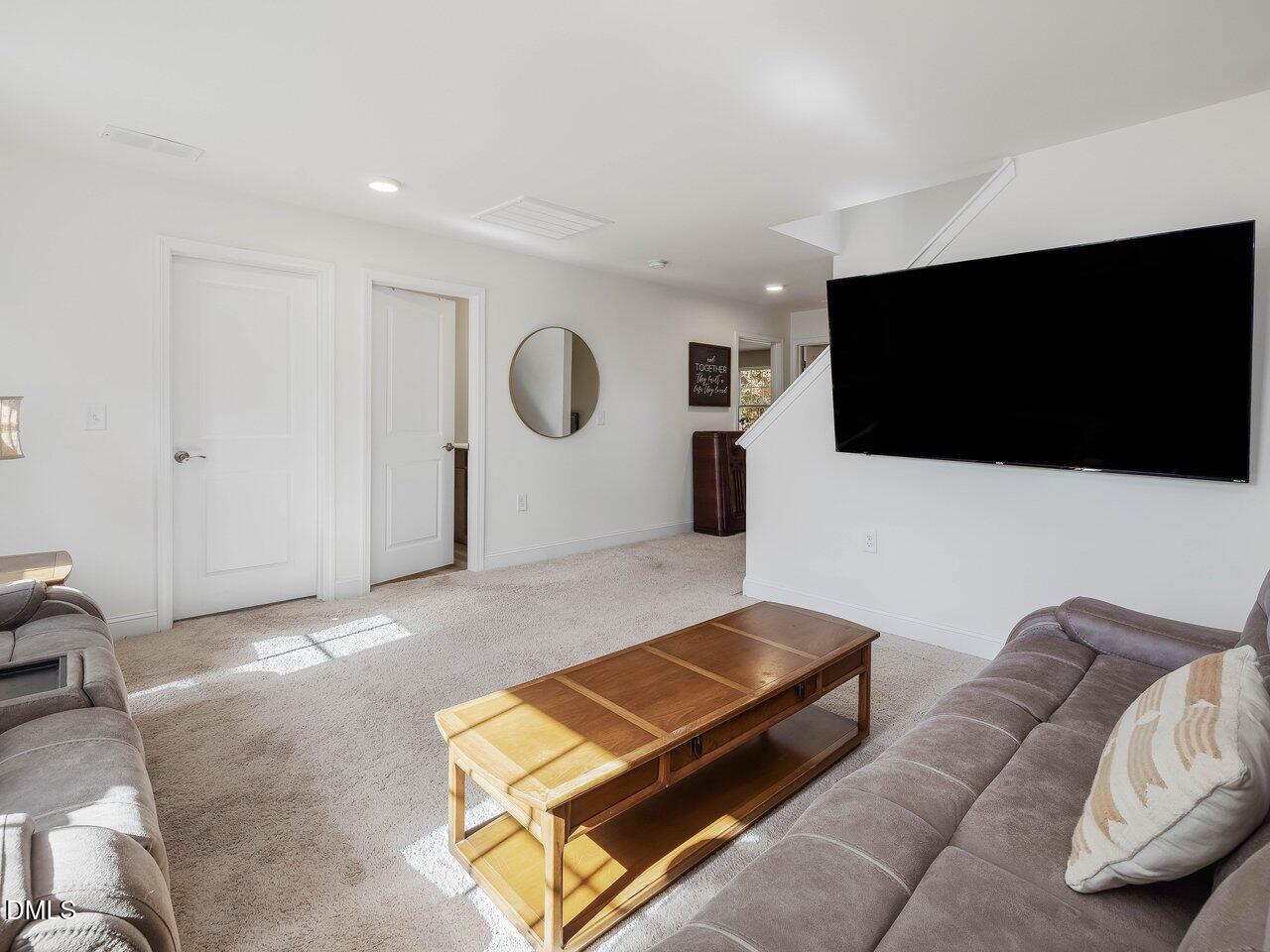 718 Heartpine Drive Mebane, NC 27302 - Photo 32 of 62 a living room with furniture and a flat screen tv