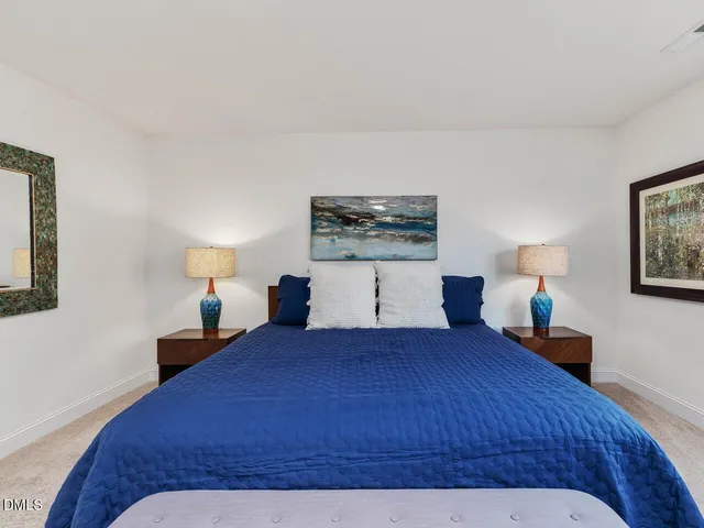 a spacious bathroom with a tub sink and mirror