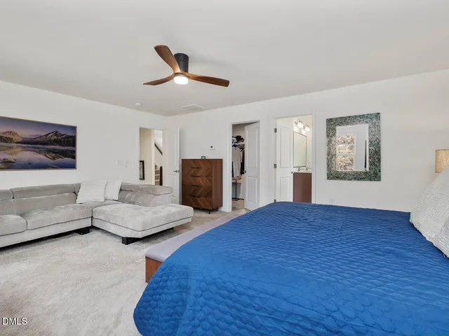 a living room with a bed furniture and a window