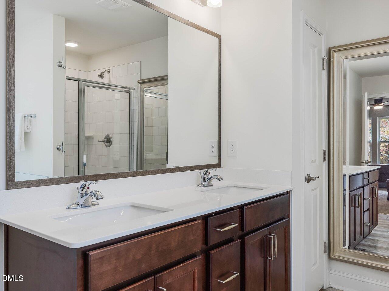 718 Heartpine Drive Mebane, NC 27302 - Photo 37 of 62 a bathroom with a sink double vanity and a mirror
