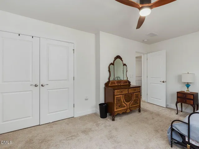 a bathroom with a sink a toilet a mirror and shower