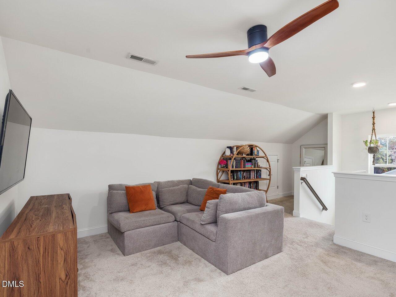 718 Heartpine Drive Mebane, NC 27302 - Photo 45 of 62 a living room with furniture and a flat screen tv