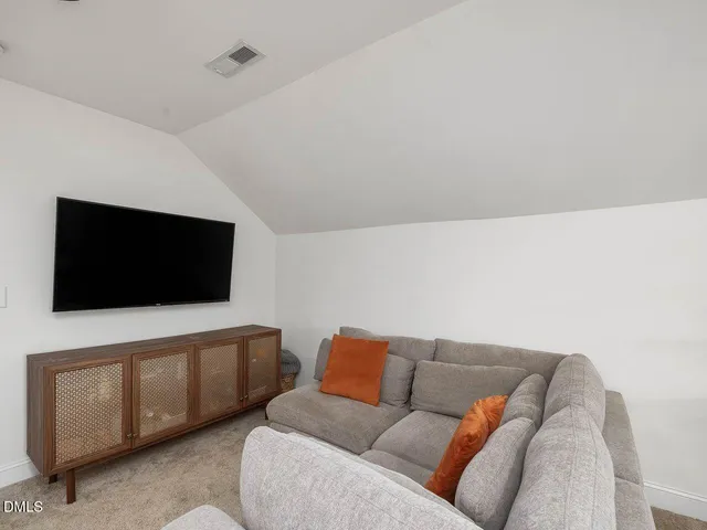 an aerial view of a house with a mountain