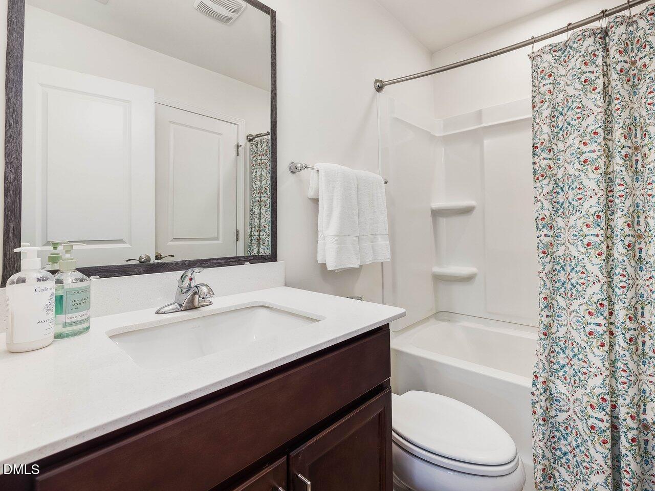 718 Heartpine Drive Mebane, NC 27302 - Photo 51 of 62 a bathroom with a sink a toilet a mirror and shower