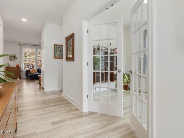a view of a bedroom with wooden floor and windows