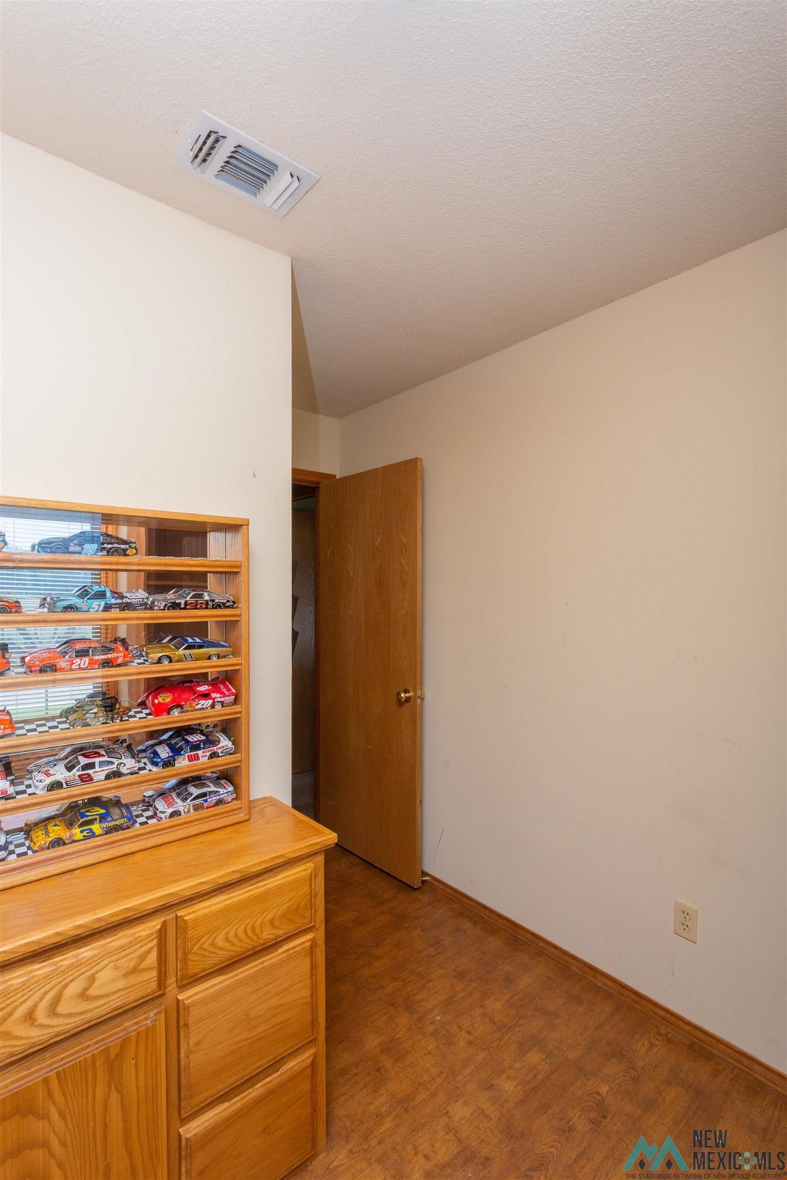 2012 South Haldeman Road Artesia, NM 88210 - Photo 43 of 96 Warm wood-finish flooring complements the neutral wall color