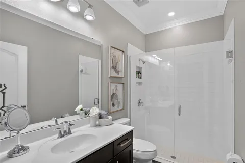 a bathroom with a sink toilet a mirror and shower