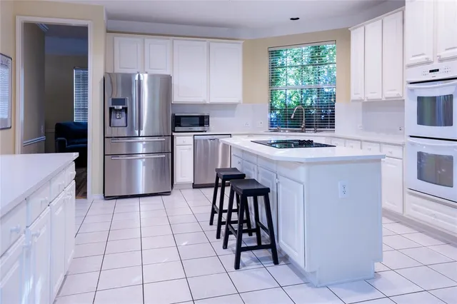 a kitchen with a stove a refrigerator and a sink
