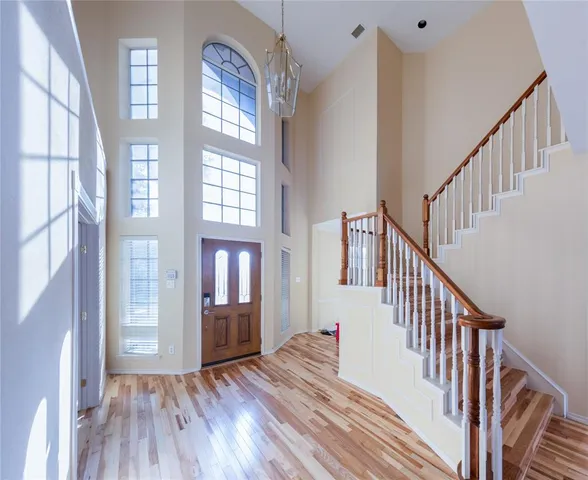 a view of an entryway with wooden floor and windows