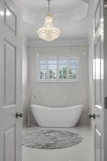 a bathroom with a shower and a bath tub