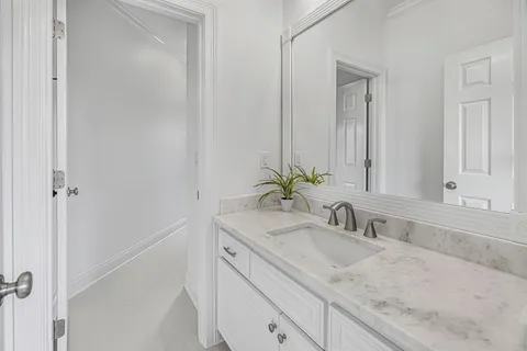 a bathroom with a toilet sink and a mirror