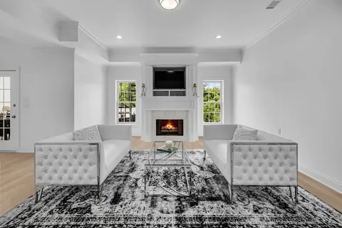a view of a dining room with furniture and chandelier