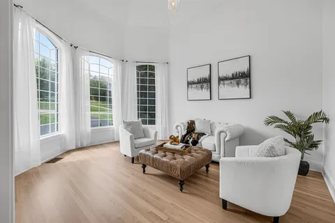a bedroom with a bed and a flat tv screen on dresser