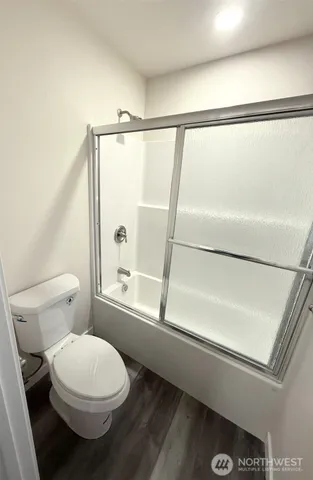 a bathroom with a toilet and a shower