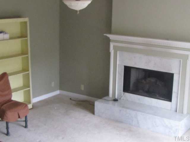 2579 Burton Road Durham, NC 27704 - Photo 4 of 14 a living room with a fireplace