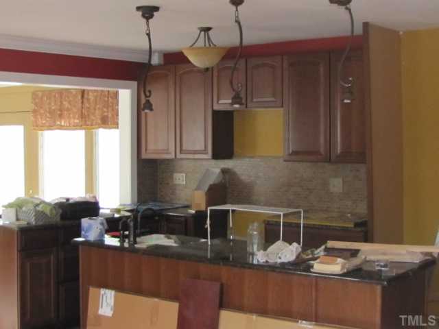 2579 Burton Road Durham, NC 27704 - Photo 5 of 14 a kitchen with sink cabinets and window
