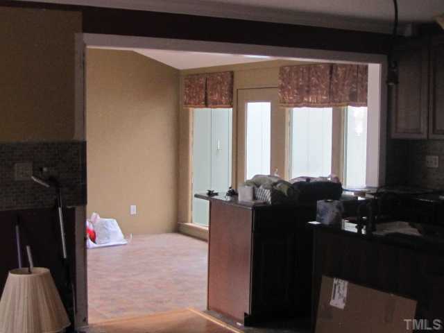 2579 Burton Road Durham, NC 27704 - Photo 7 of 14 a living room with furniture and a floor to ceiling window