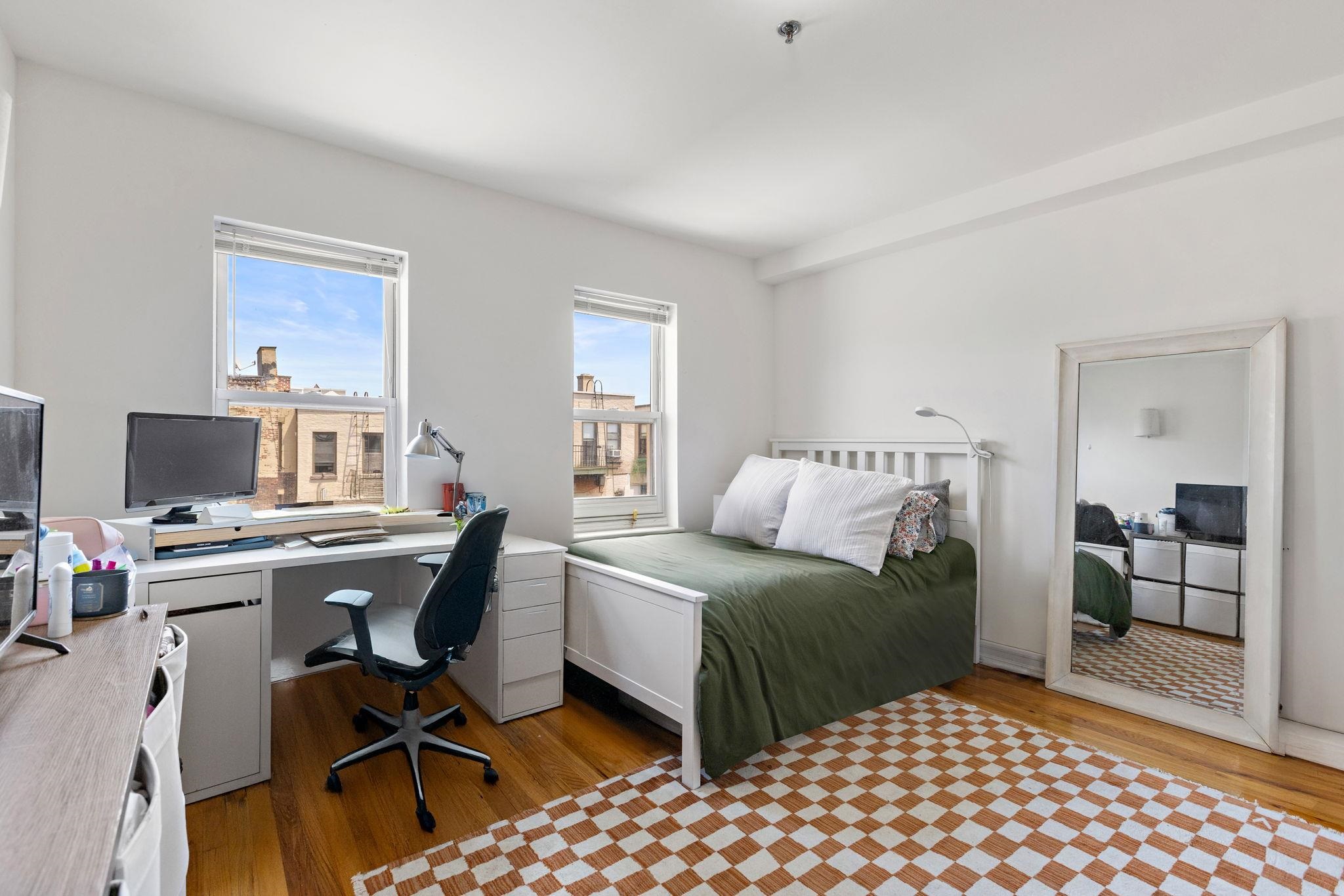 131 Clinton Street, Unit 1 Hoboken, NJ 07030 - Photo 6 of 13 a bedroom with a bed and a desk