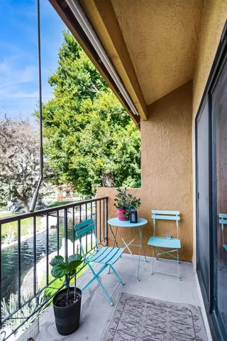 a view of a chairs and table in the balcony