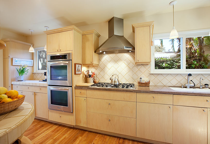 2180 East Valley Road Santa Barbara, CA 93108 - Photo 6 of 10 a kitchen with kitchen island granite countertop white cabinets and white appliances