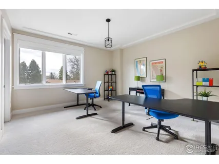a view of a livingroom with workspace and a window
