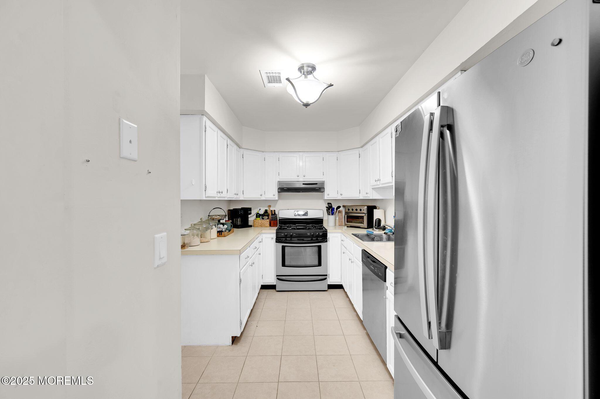 33 South Pointe Circle Tinton Falls, NJ 07753 - Photo 12 of 31 a kitchen with stainless steel appliances granite countertop a refrigerator and a stove