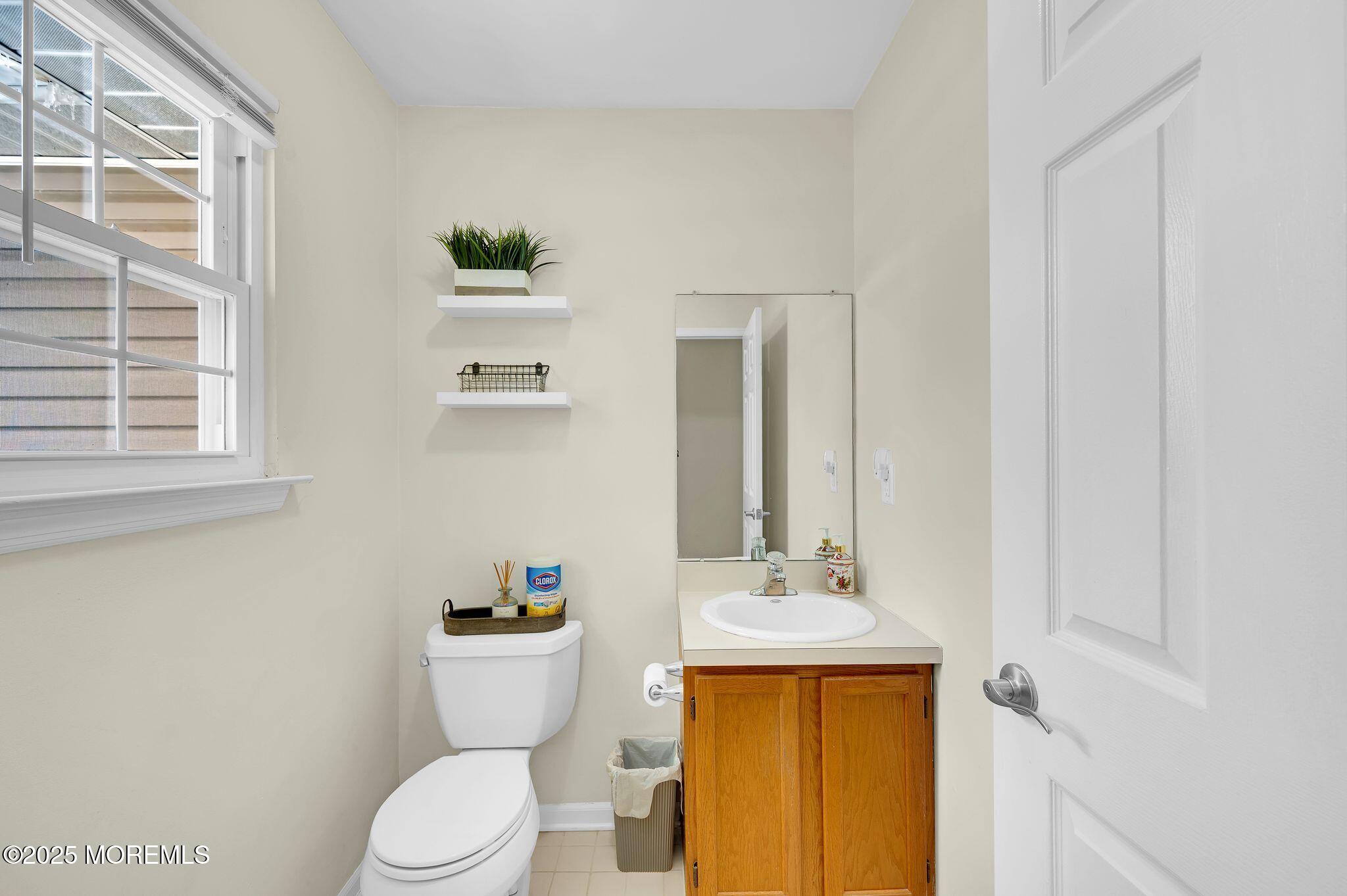 33 South Pointe Circle Tinton Falls, NJ 07753 - Photo 14 of 31 a bathroom with a toilet sink and mirror