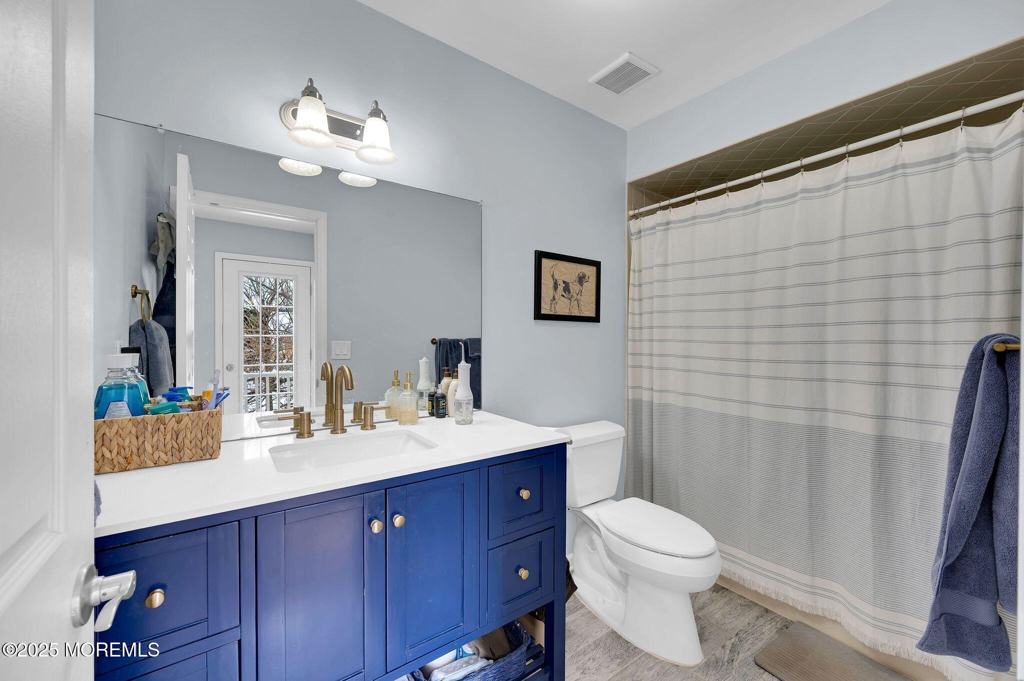 33 South Pointe Circle Tinton Falls, NJ 07753 - Photo 18 of 31 a bathroom with a toilet a sink and mirror