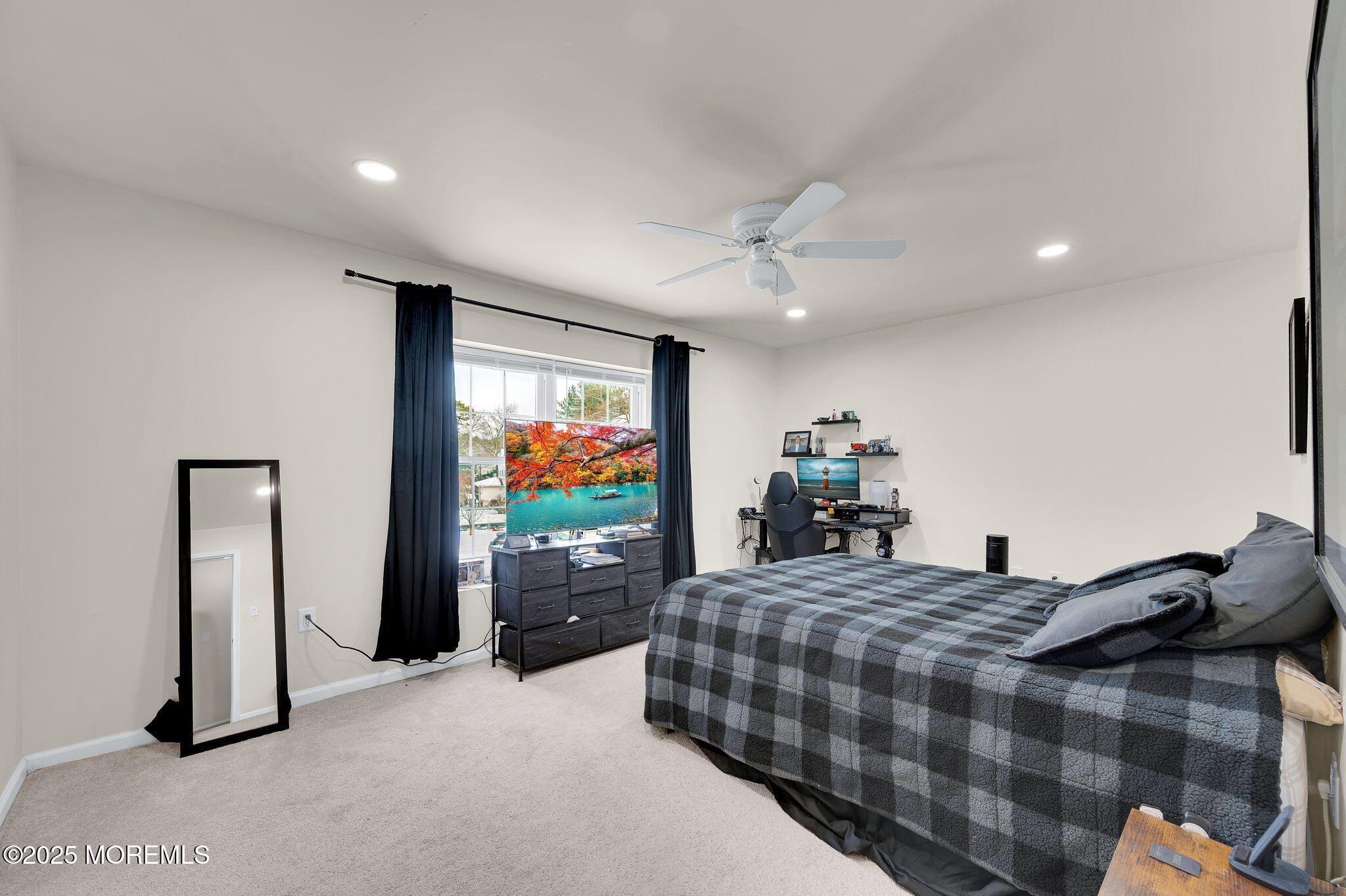 33 South Pointe Circle Tinton Falls, NJ 07753 - Photo 20 of 31 a bedroom with a bed and a flat tv screen