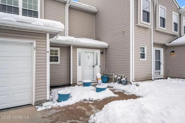 a view of a patio with a table and chairs and ice snow