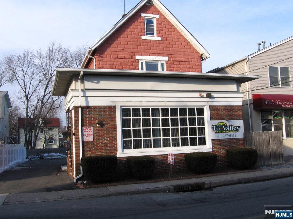 64 East Madison Avenue, Unit #2 Dumont, NJ 07628 - Photo 1 of 14 a front view of a house with a large window