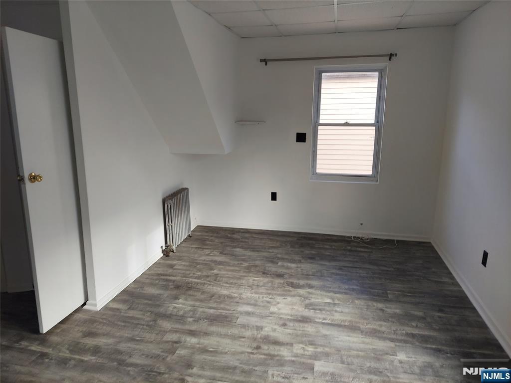 64 East Madison Avenue, Unit #2 Dumont, NJ 07628 - Photo 13 of 14 wooden floor in an empty room with a window