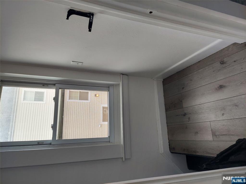 64 East Madison Avenue, Unit #2 Dumont, NJ 07628 - Photo 3 of 14 a view of a small space with wooden floor and a window