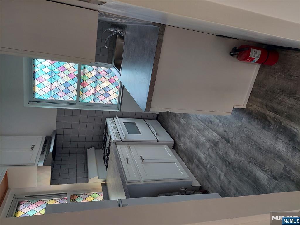 64 East Madison Avenue, Unit #2 Dumont, NJ 07628 - Photo 4 of 14 a kitchen with a stove and a sink